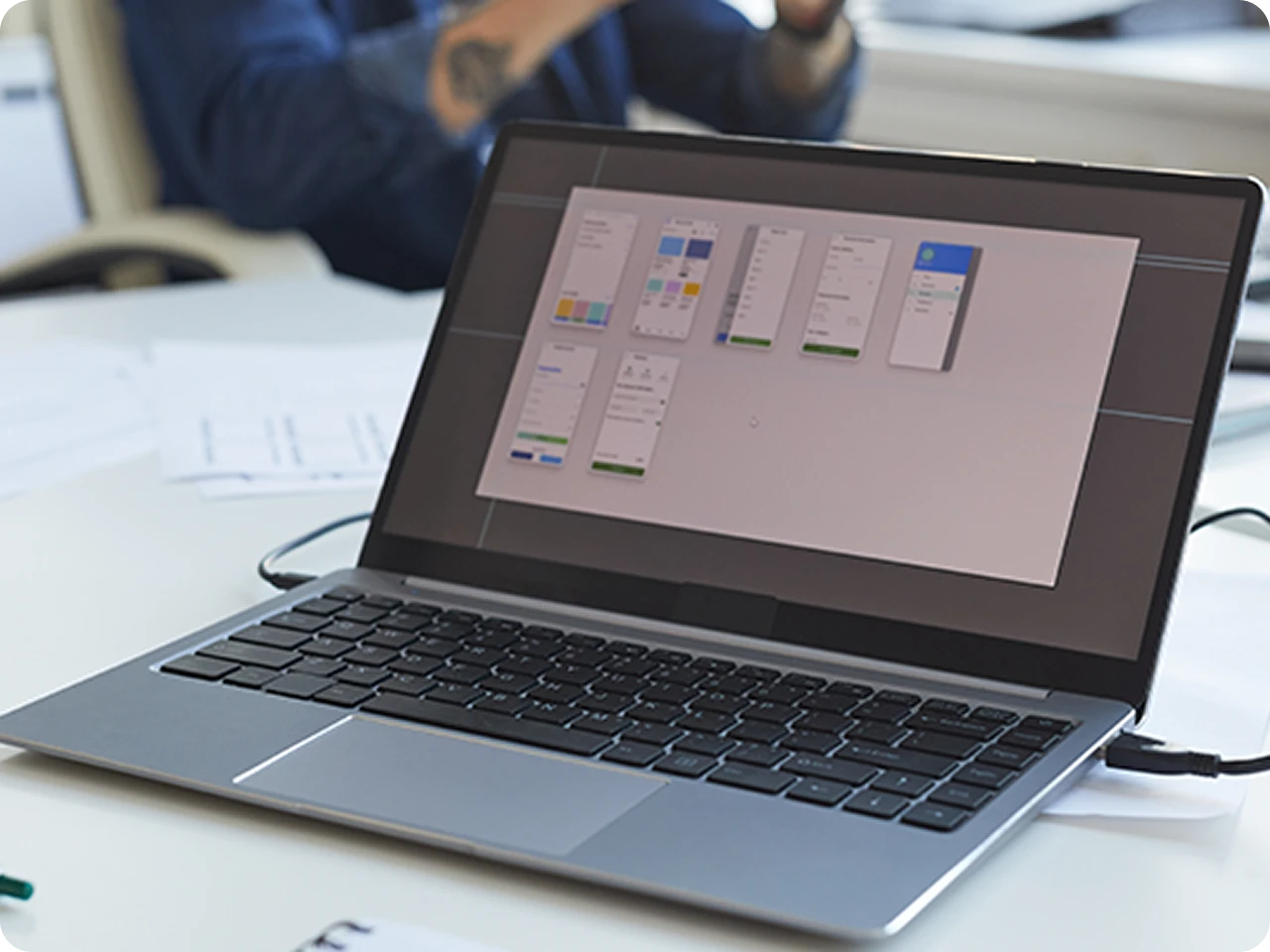 Laptop displaying website design layouts