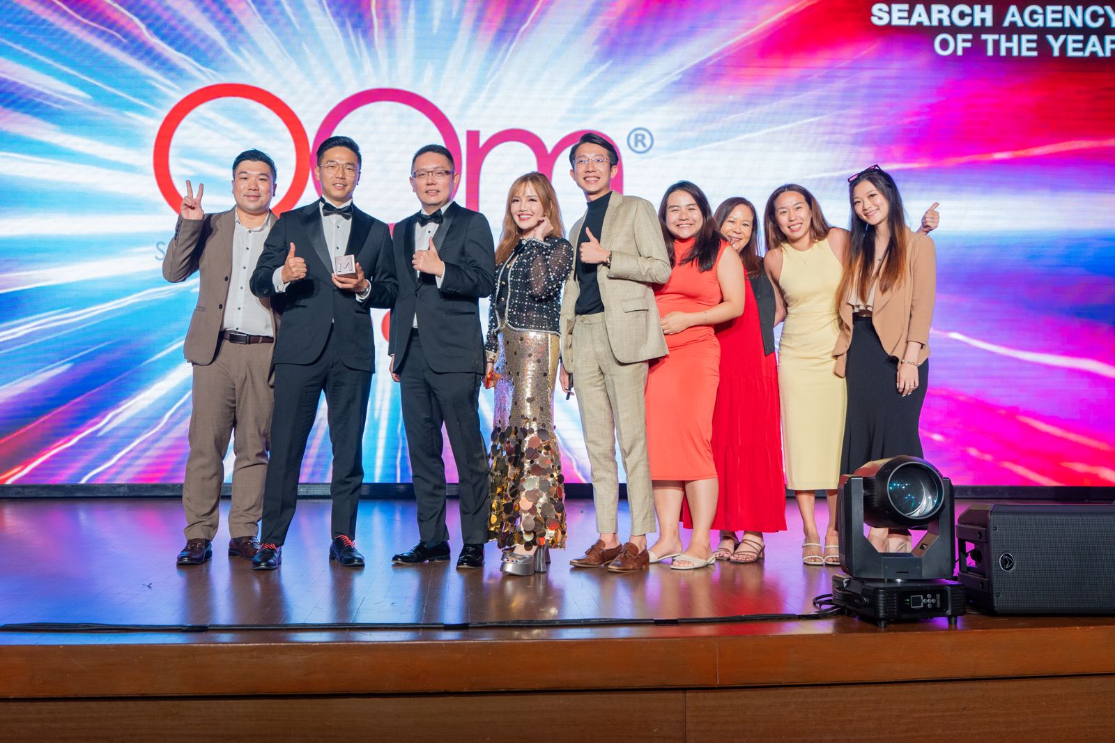 OOm team posing on stage after winning Bronze at AOTY Awards 2025